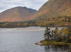 The southern point of the island among the beautiful fall foliage of the surrounding mountains. The North Aspy River can be seen emptying into the harbour at centre of photo.