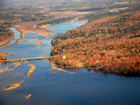 Aerial view shows river area above bridge - great area for small boating and enjoying nature. Yellow dot indicates location of property.