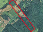 Vertical air photo with property outlined in red.