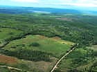 An aerial view of the property and surrounding region. The property is located on the bottom, right-hand side of this photo.