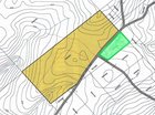The property is highlighted in green on this topographical map of the area. The property shaded in yellow is a previously-sold lot.