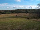 The property can be seen in the distance, beyond the cleared fields.