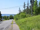 Property extends down hill (from the pole with transformer) to Shore Road.