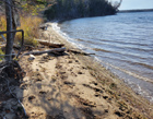 View of the property's sandy beach and the surrounding landscape.